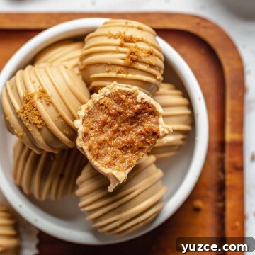 A bite removed from a biscoff truffle.