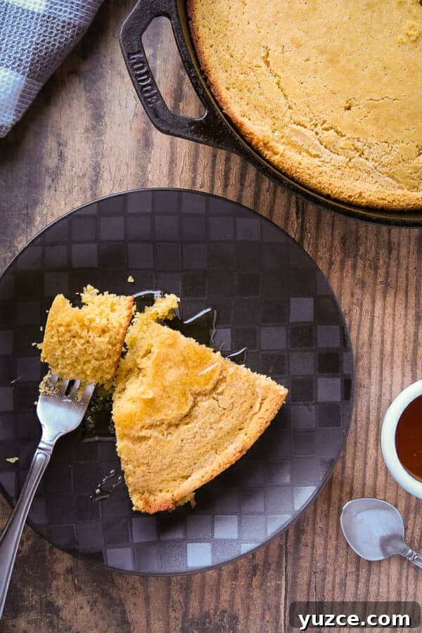 Buttery Skillet Cornbread Recipe — Moist Homemade Cornbread 2 overhead shot of a slice of the cornbread