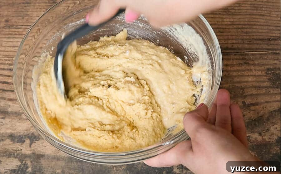 Buttery Skillet Cornbread Recipe — Moist Homemade Cornbread 3 mixing the batter for the skillet cornbread