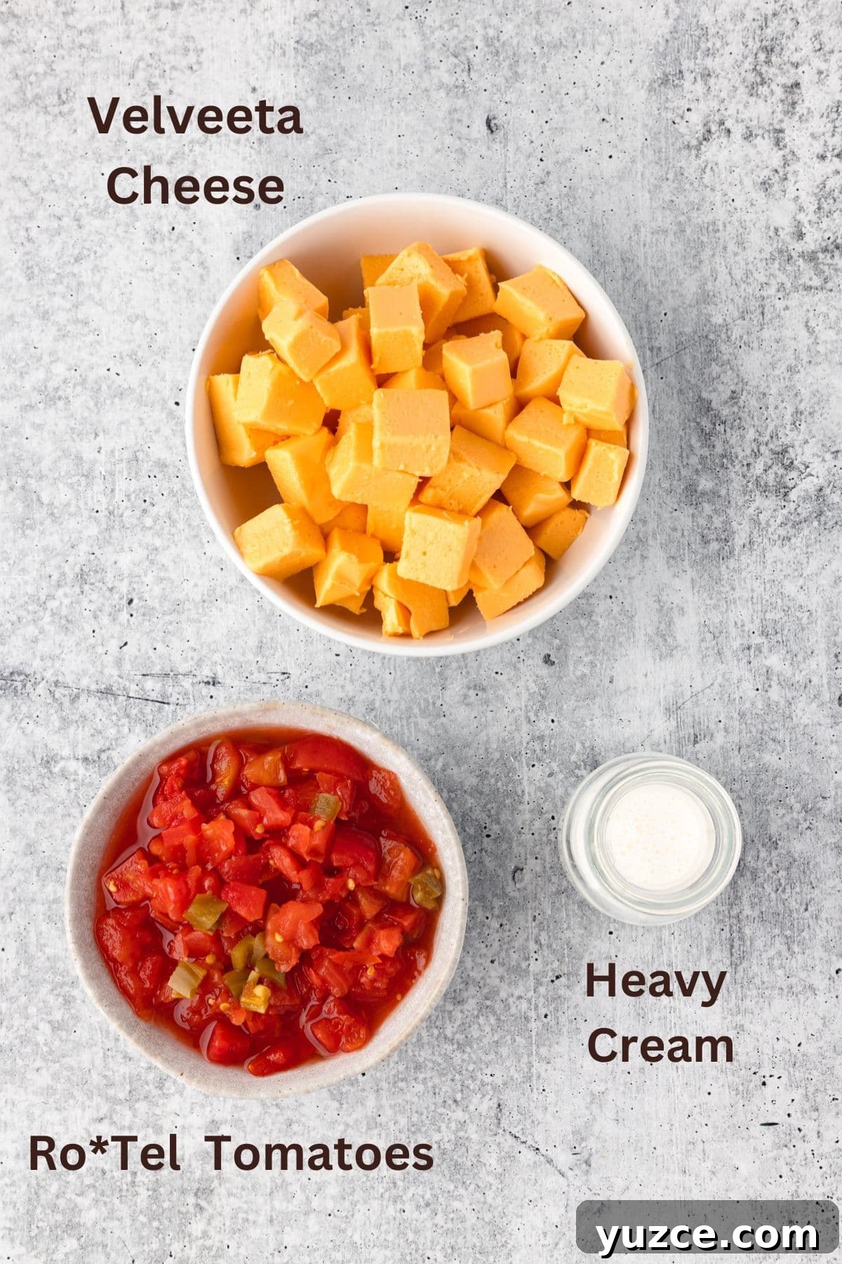 Creamy Velveeta Cheese Dip Recipe for Parties and Game Day 4 Cheddar cheese cubes, diced tomatoes, and heavy cream ingredients for velveeta cheese recipe.