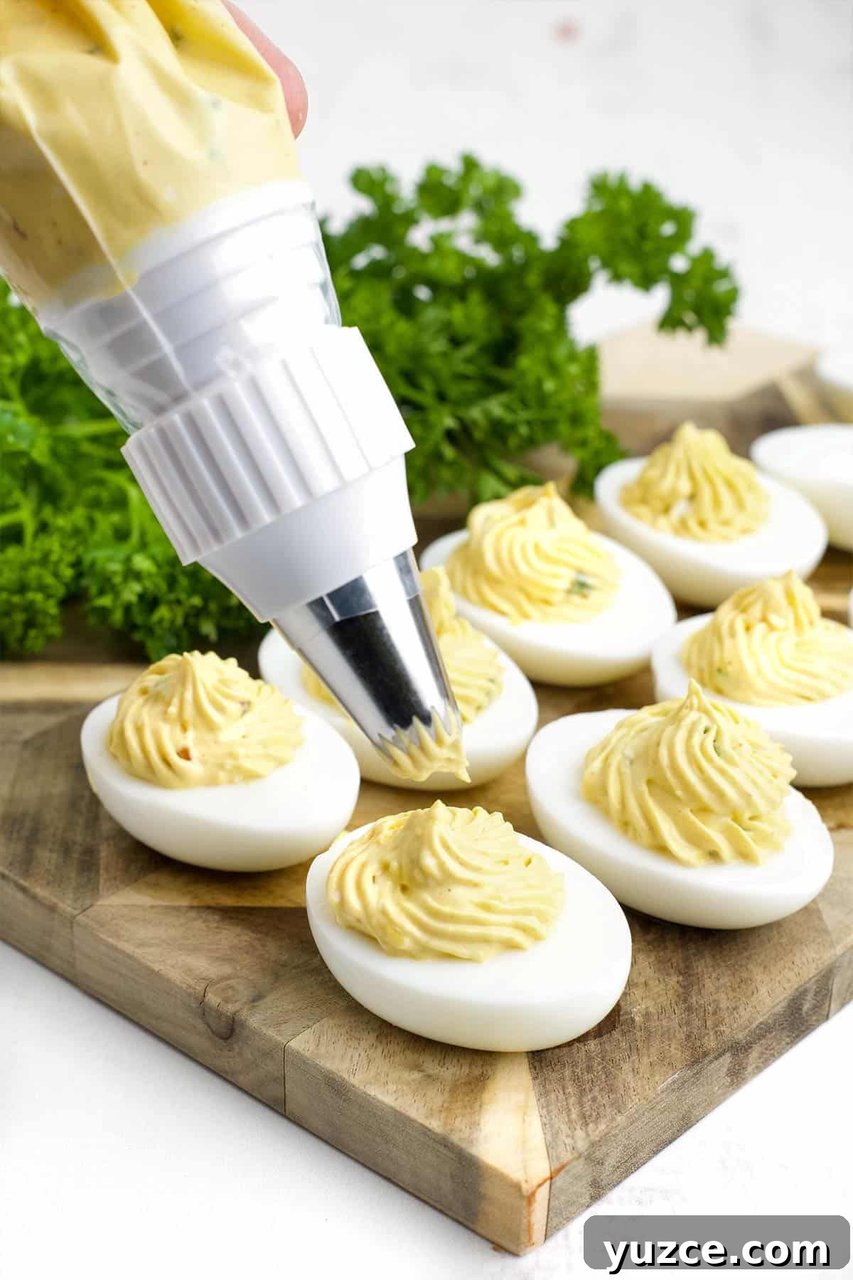 Jalapeño Bacon Deviled Eggs: Spicy Party Appetizer Recipe 5 Piping the egg whites with the spicy egg filling.