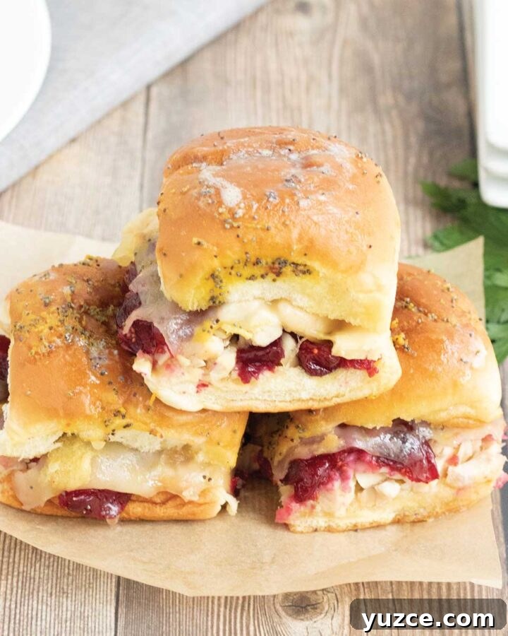 three cranberry turkey sliders baked in the oven.