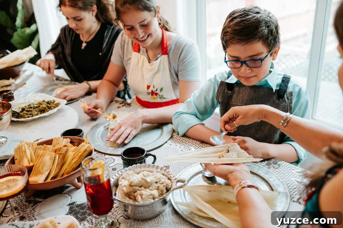 How to Host a Tamalada: Step-by-Step Tamal-Making Party Guide 3 Latina woman showing a little boy how to spread massa on a corn husk at a tamalada.