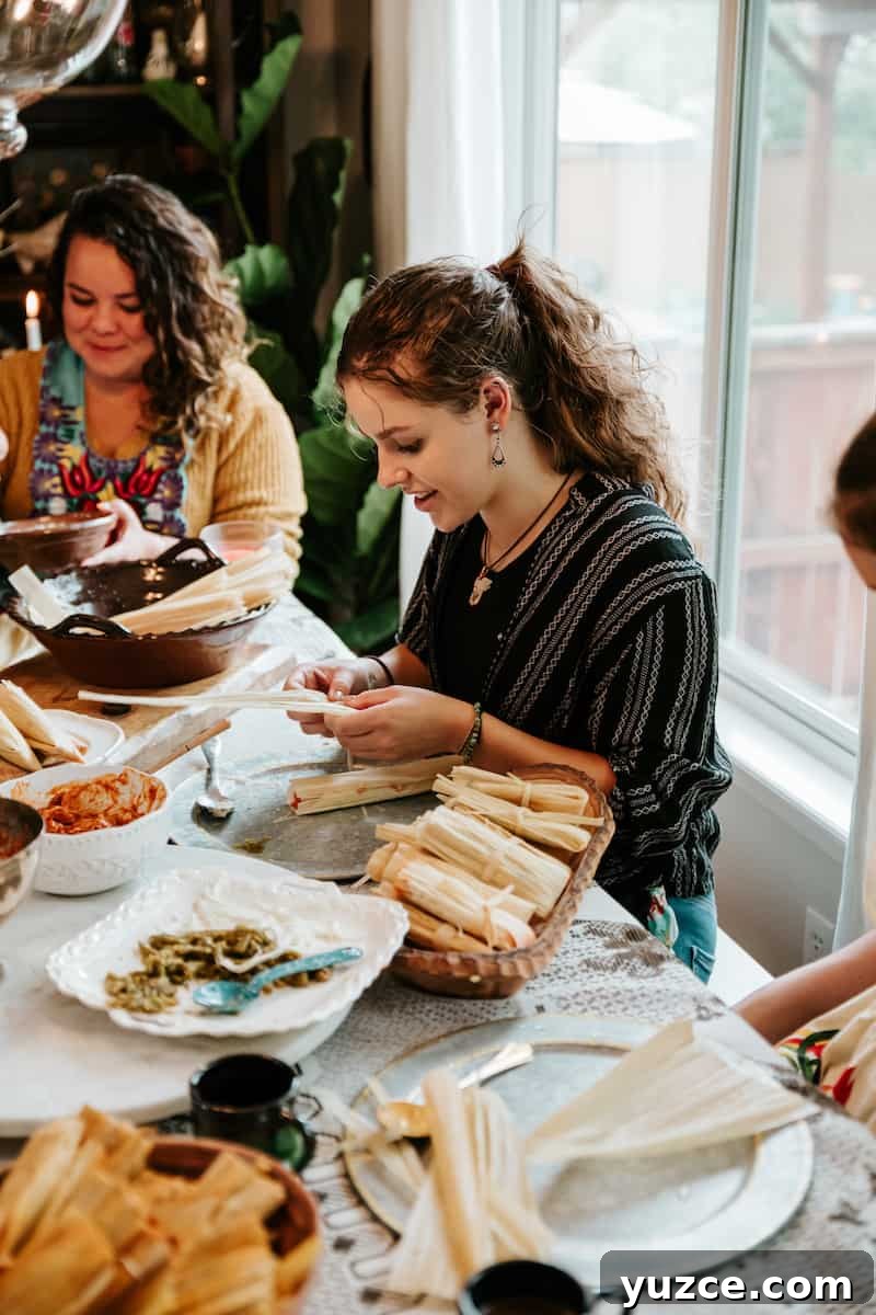 How to Host a Tamalada: Step-by-Step Tamal-Making Party Guide 4 young woman rolling a tamal at a tamalada party.