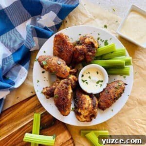 Crispy Cajun Chicken Wings Recipe: Spicy Oven-Baked Wings 9 cajun wings recipe on a plate with celery and dip