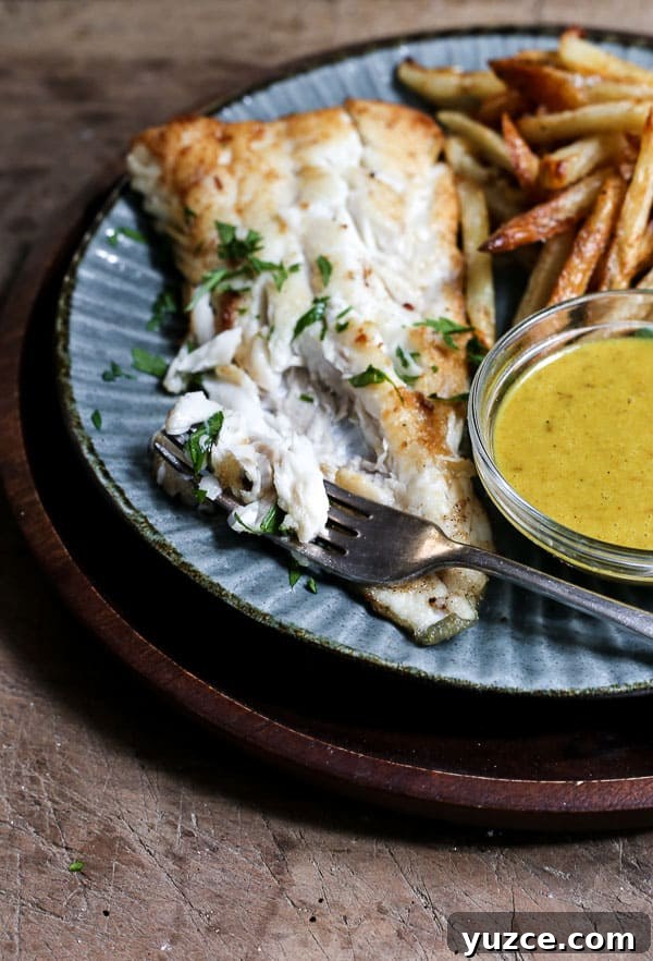 Crispy Gluten-Free Fish and Chips Recipe for Home Cooking 3 A plate of fish and chips with curry sauce with a bite taken out