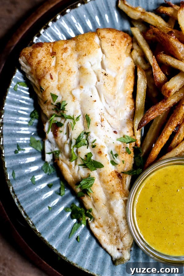 Crispy Gluten-Free Fish and Chips Recipe for Home Cooking 5 A plate of fish and chips with curry sauce