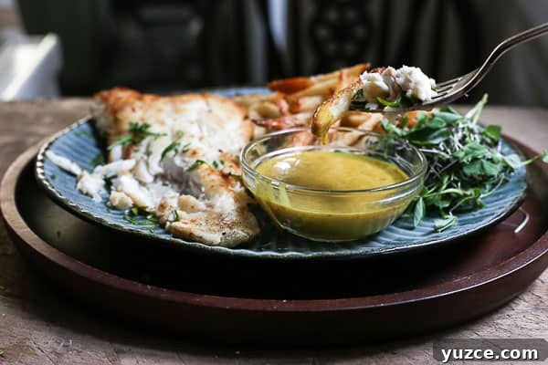 Crispy Gluten-Free Fish and Chips Recipe for Home Cooking 9 A plate of fish and chips with curry sauce
