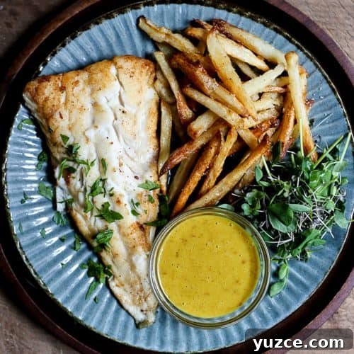 Crispy Gluten-Free Fish and Chips Recipe for Home Cooking 10 A plate of fish and chips with curry sauce