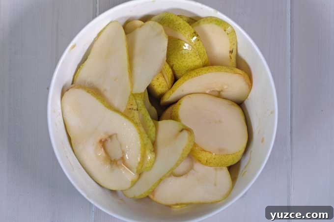 Maple Pear Crostini: Quick Fall Appetizer with Warm Flavor 7 Top down view of bartlett pears sliced into thin pieces | Foodal