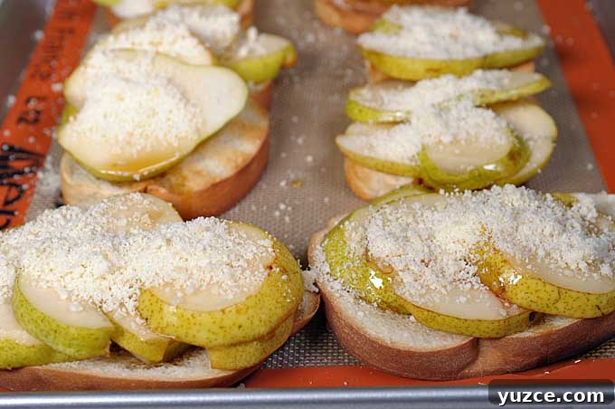 Maple Pear Crostini: Quick Fall Appetizer with Warm Flavor 8 Close up shot of crostini on a Silpat silicone baking mat on a cookie sheet | Foodal
