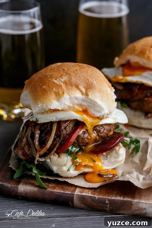 Aussie Drunken Burger Recipe: Beer-Braised Beef with Caramelized Onions 2 Side view of Drunken Aussie Beef Burgers on plate