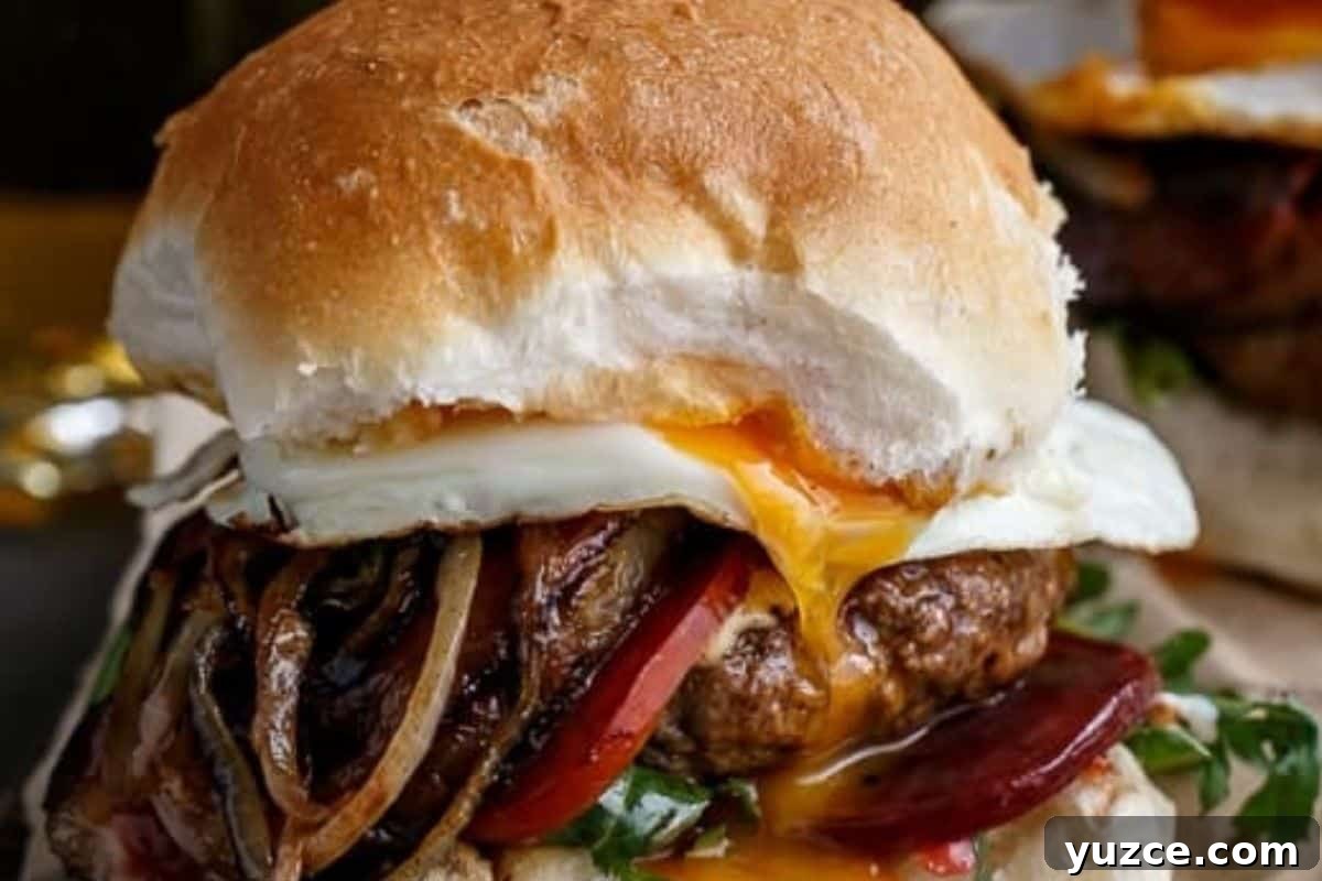Aussie Drunken Burger Recipe: Beer-Braised Beef with Caramelized Onions 11 Layer buns with lettuce, beetroot, a patty, cheese, pineapple, bacon, onion, tomato, and a fried egg. Drizzle with tomato sauce and mayonnaise, then top with the remaining bun.
