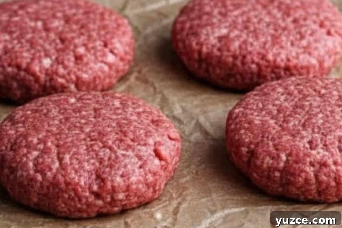 Aussie Drunken Burger Recipe: Beer-Braised Beef with Caramelized Onions 5 Divide the mixture into four equal portions and form each one into a firm, round patty about 1 inch thick.