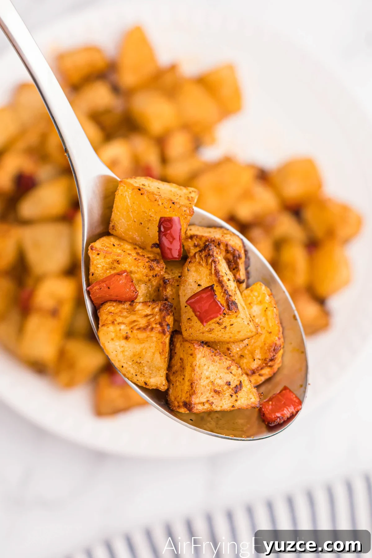 Crispy Air Fryer Home Fries Recipe for Breakfast or Brunch 10 Spoonful of home fries made in the air fryer, ready to serve.