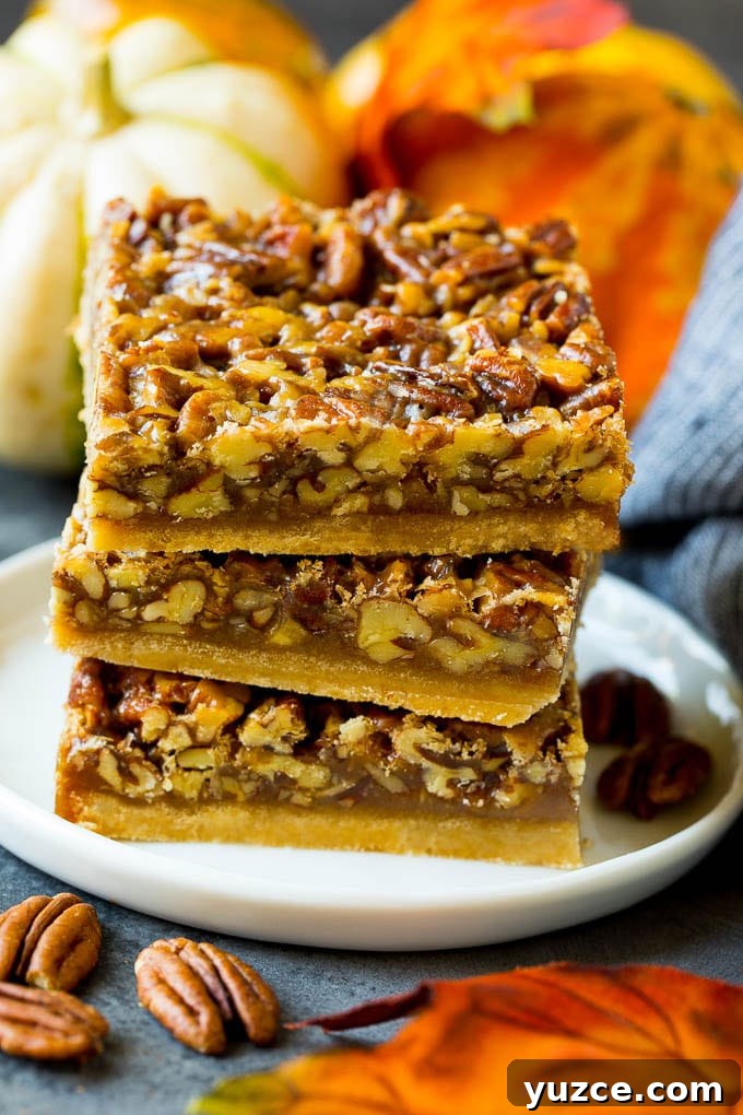 Stack of pecan pie bars A stack of pecan pie bars on a plate.