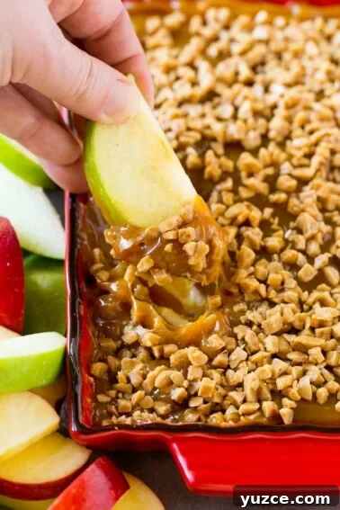 Irresistible Pecan Pie Bars Recipe with Buttery Shortbread Crust 4 A hand scooping caramel apple dip.