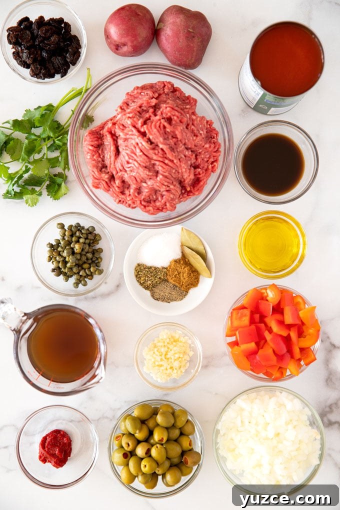 Authentic Cuban Picadillo Recipe with Sofrito and Raisins 4 Ingredients to make beef picadillo set in bowls on a marble counter.