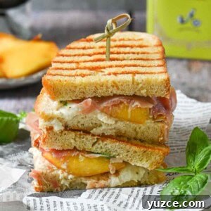 Peach, Prosciutto & Burrata Panini Recipe for Summer Sandwiches 12 Peach panini stacked on deli paper with basil and peaches in the background.
