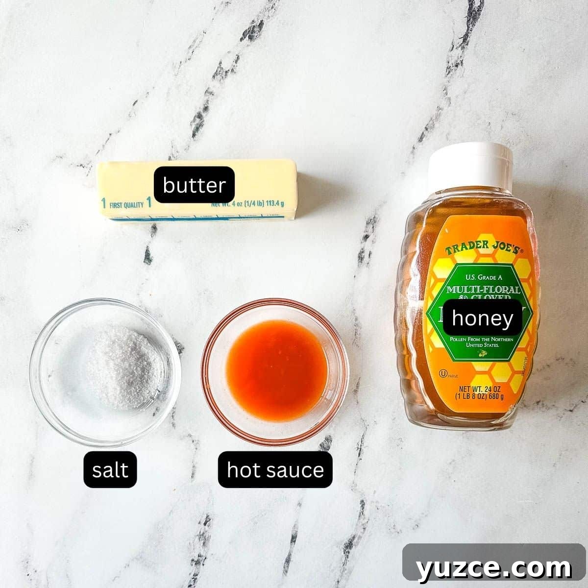 Homemade Hot Honey Sauce Recipe for Spicy-Sweet Dishes 3 Labeled ingredients for hot honey sauce on a white marble counter.