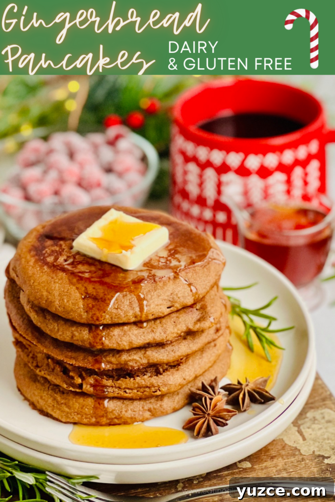 Gingerbread Pancakes with Warm Molasses Syrup 2 A white plate filled with dark brown colored round pancakes with a large square of melty butter and syrup running down the top with a bright red mug of coffee in the background.