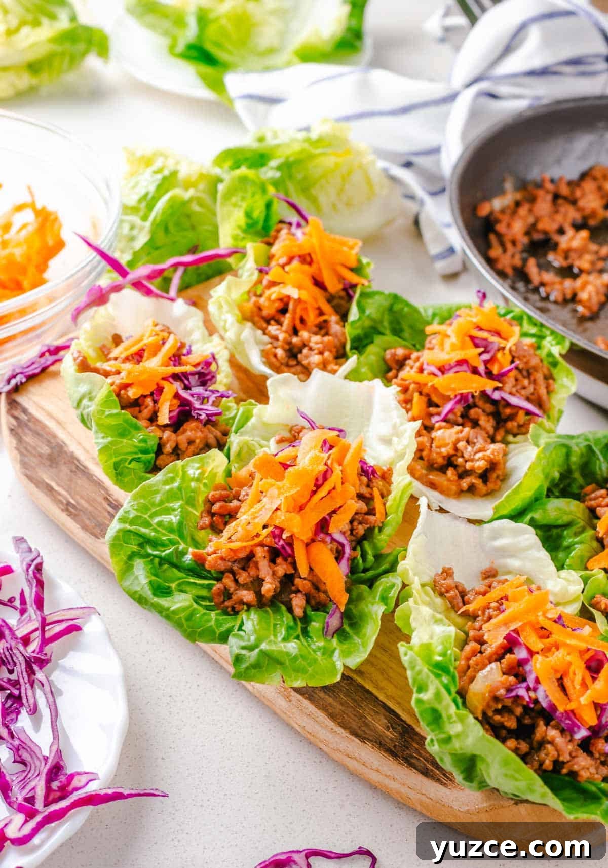 Ground Beef Lettuce Wraps with Hoisin Lime Sauce 10 Multiple beef lettuce wraps on a cutting board.