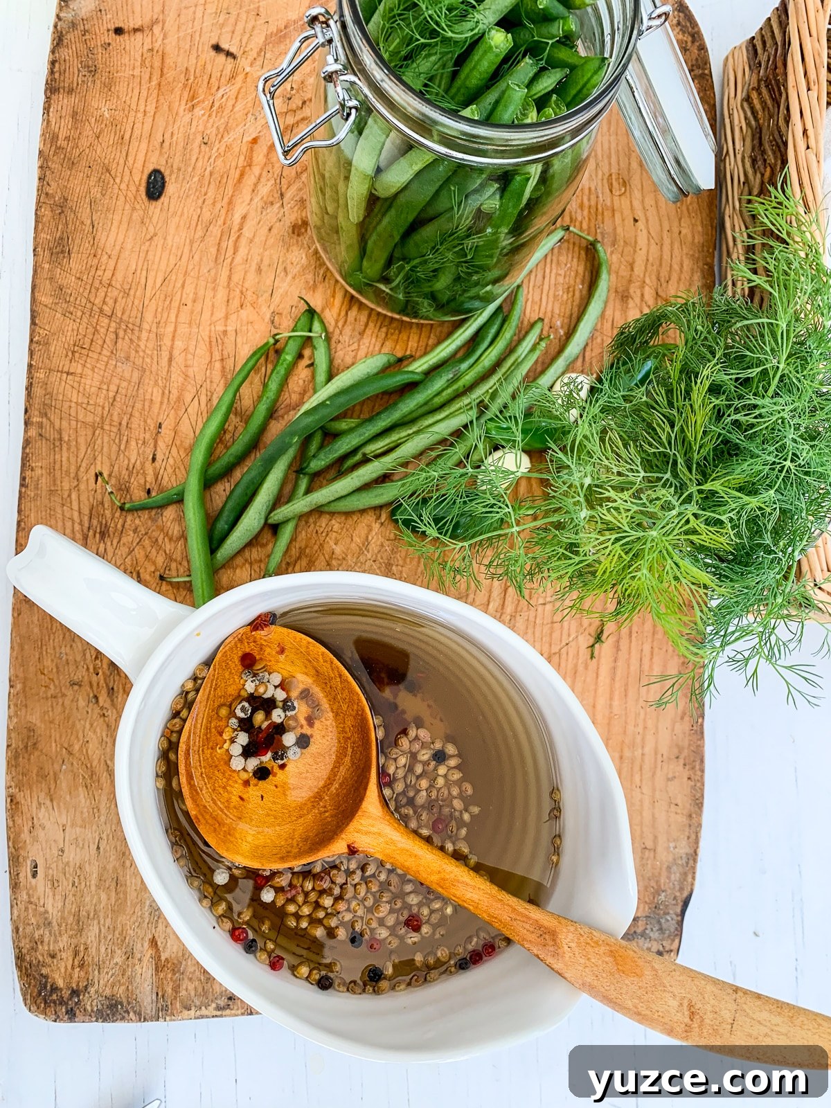 Dilly Pickled Green Beans Recipe: Classic Refrigerator Dilly Beans 9 A cutting board with all the ingredients to make green bean pickles.