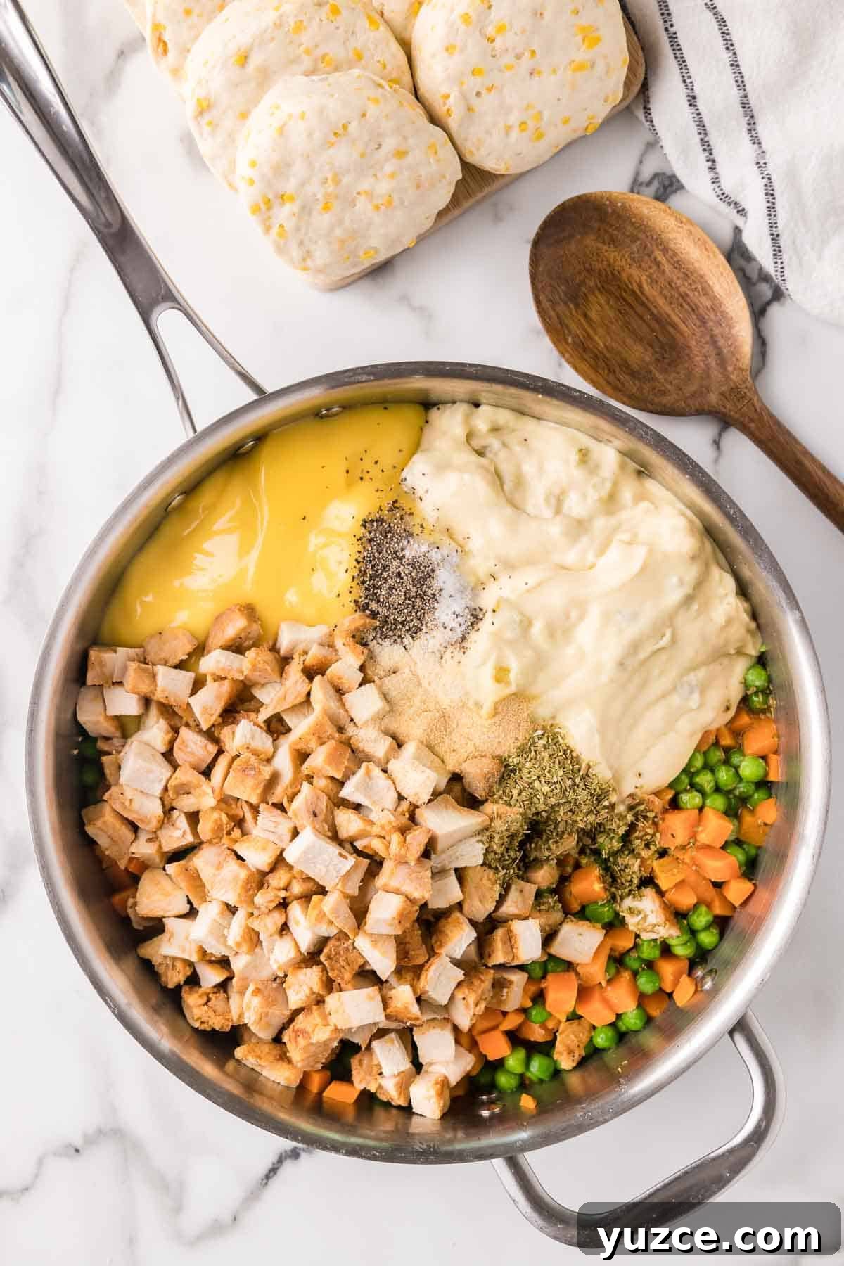 Chicken Pot Pie Casserole Topped with Golden Biscuits 4 Chicken pot pie casserole filling ingredients added to a large skillet