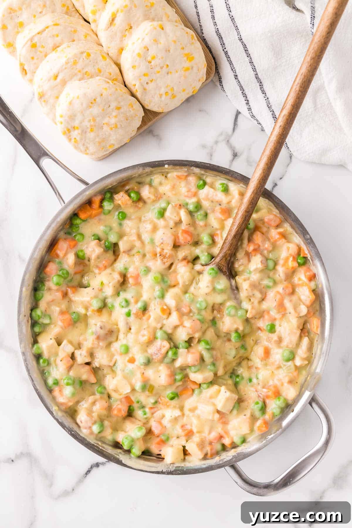 Chicken Pot Pie Casserole Topped with Golden Biscuits 5 Chicken pot pie filling mixed in a large skillet