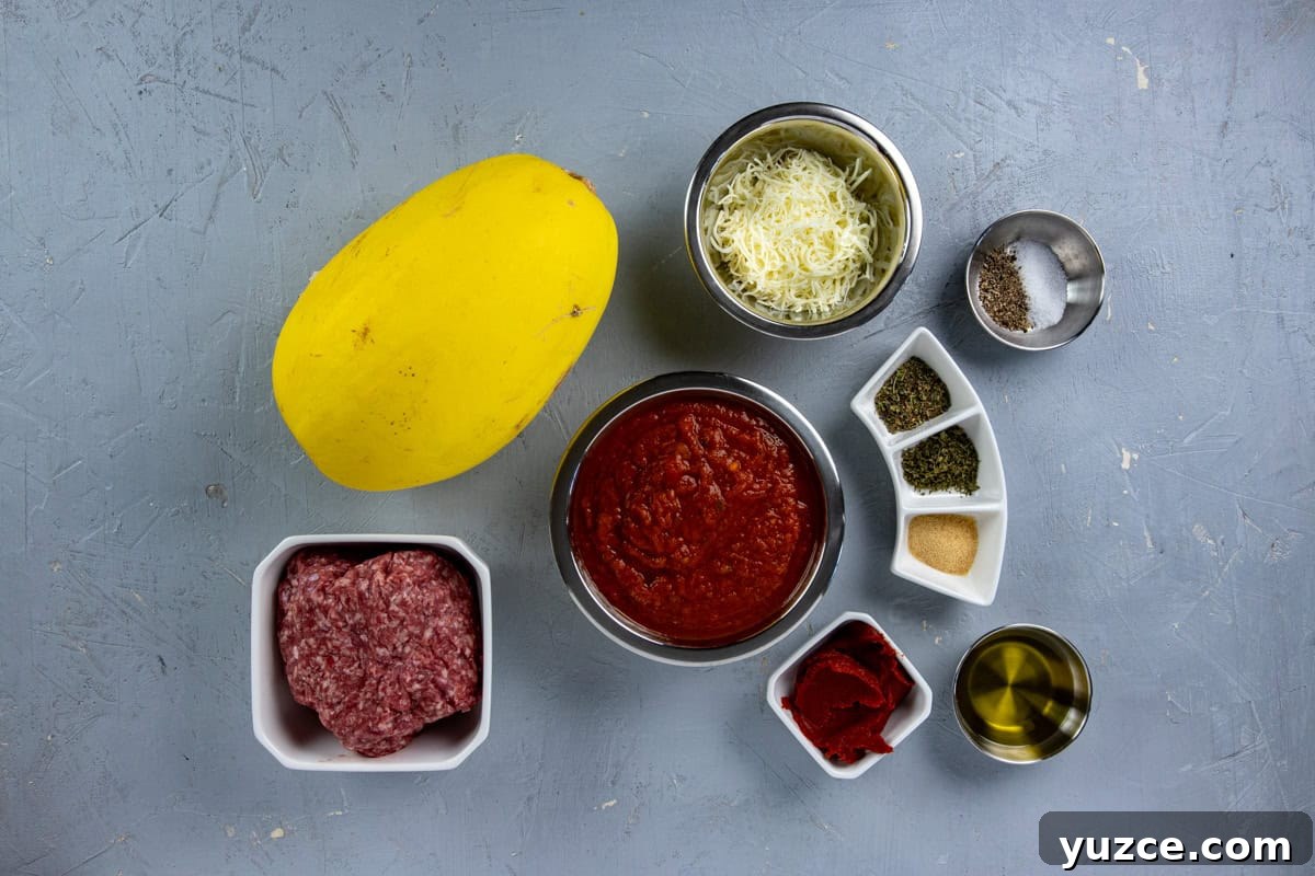 Cheesy Stuffed Spaghetti Squash Recipe with Italian Sausage 3 Ingredients measured out in individual containers on countertop.