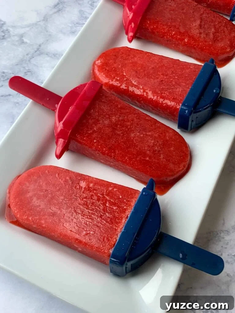 Simple strawberry popsicles on white tray