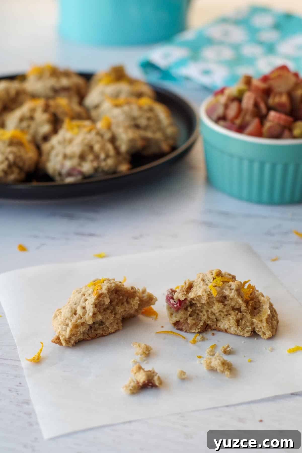 Brown Sugar Oatmeal Cookies with Tangy Rhubarb 2 rhubarb oatmeal cookie, broken in half, on a piece of parchment paper
