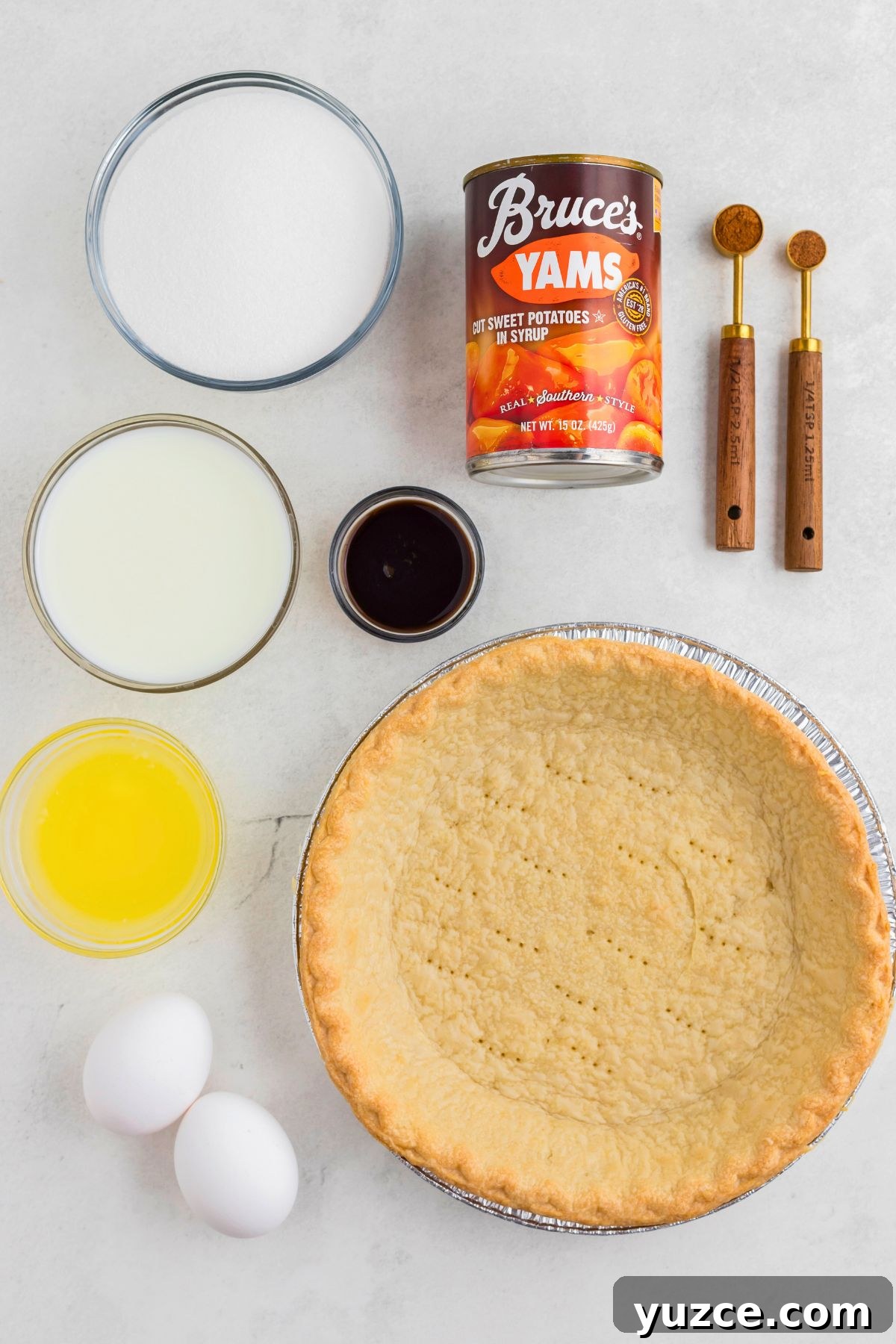 Classic Southern Sweet Potato Pie Recipe — Step-by-Step Guide 3 Ingredients measured out in small clear bowls on a marble table.