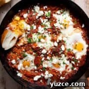 Perfect Shakshuka Recipe: Flavorful One-Pan Eggs and Tomatoes 18 Healthy shakshuka with poached eggs, tomato sauce, and feta cheese served in a cast iron pan