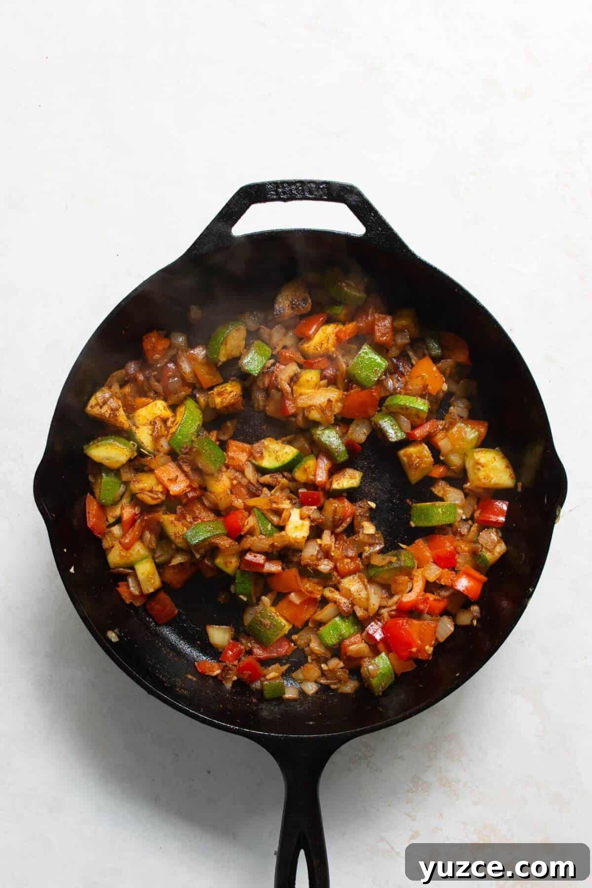 Perfect Shakshuka Recipe: Flavorful One-Pan Eggs and Tomatoes 5 Adding cumin, paprika, ginger, and chili flakes to sautéed vegetables for shakshuka