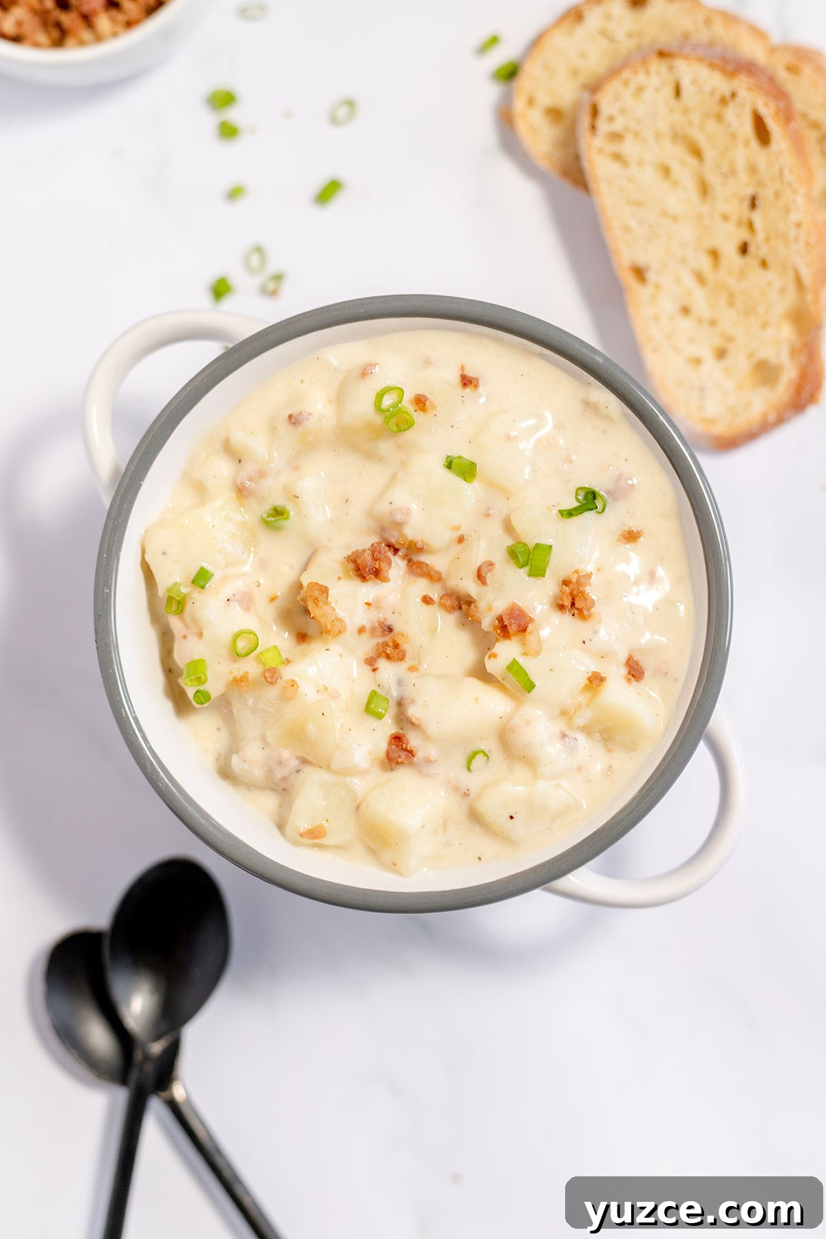 Creamy Loaded Baked Potato Soup Recipe 2 Baked Potato Soup in stockpot topped with bacon and green onions.