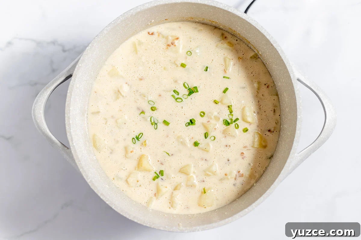 Creamy Loaded Baked Potato Soup Recipe 8 Baked Potato Soup simmering in the stock pot.
