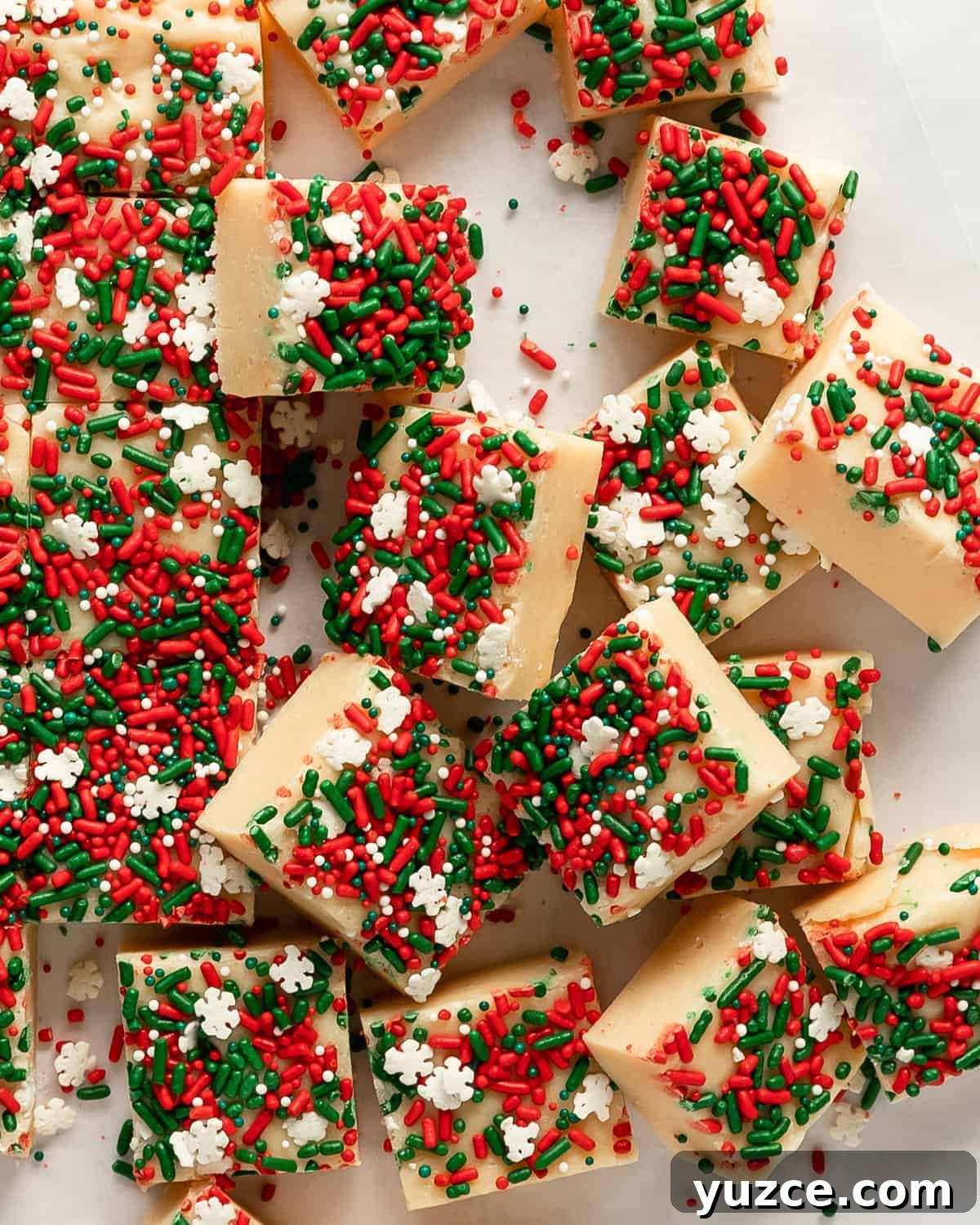 Christmas Cookie Fudge Recipe — Decadent Holiday Treat 4 White chocolate melting with sweetened condensed milk in a saucepan