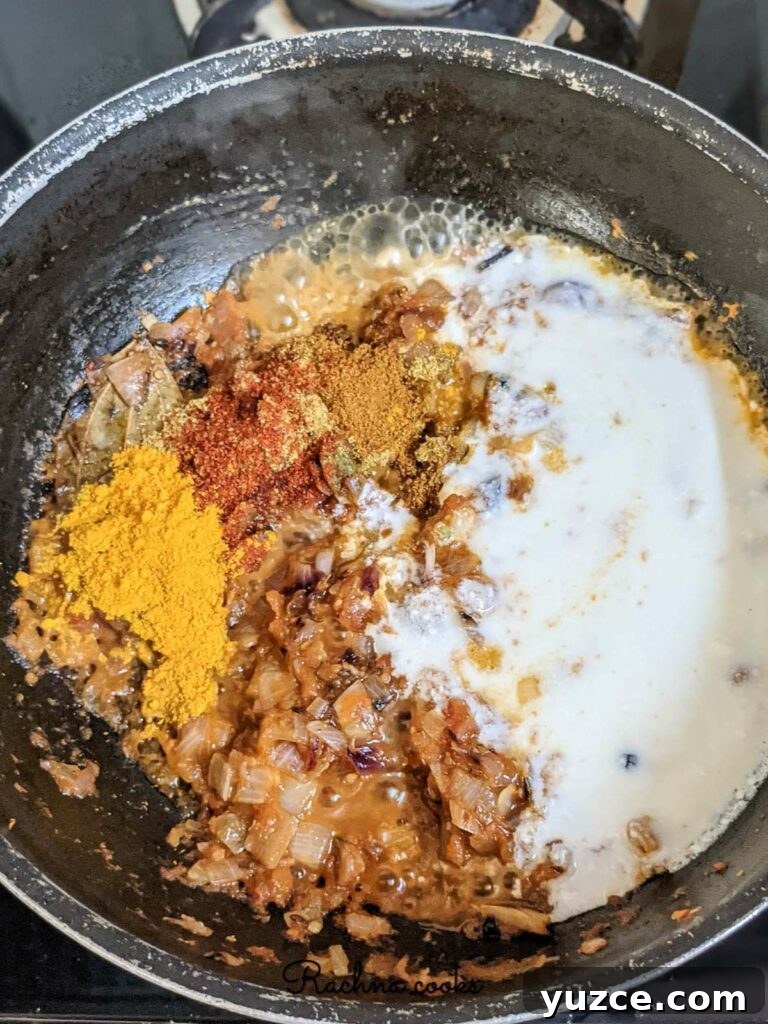 Authentic Dum Aloo Recipe: Kashmir-Style Potato Curry Guide 6 Fried onion, ginger garlic and tomatoes with yogurt and spices in a pan