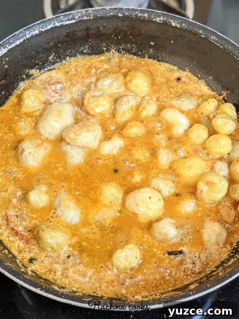 Authentic Dum Aloo Recipe: Kashmir-Style Potato Curry Guide 7 Simmering dum aloo curry