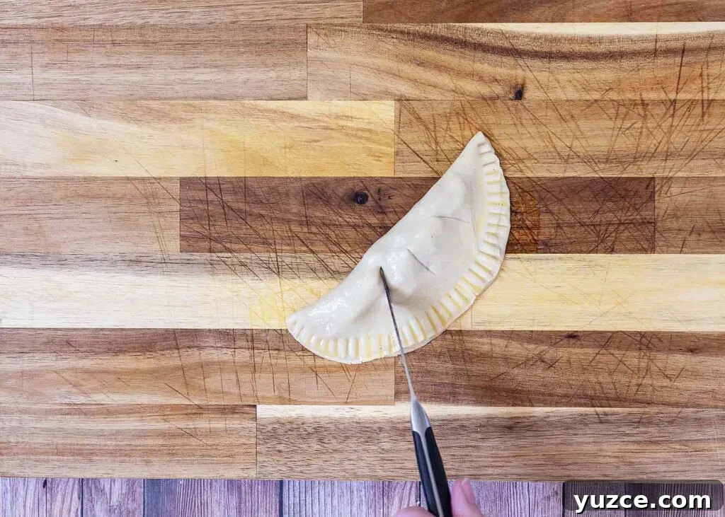 Air-Fried Apple Empanadas Recipe: Crispy Homemade Dessert 8 Cut slits for steam to escape