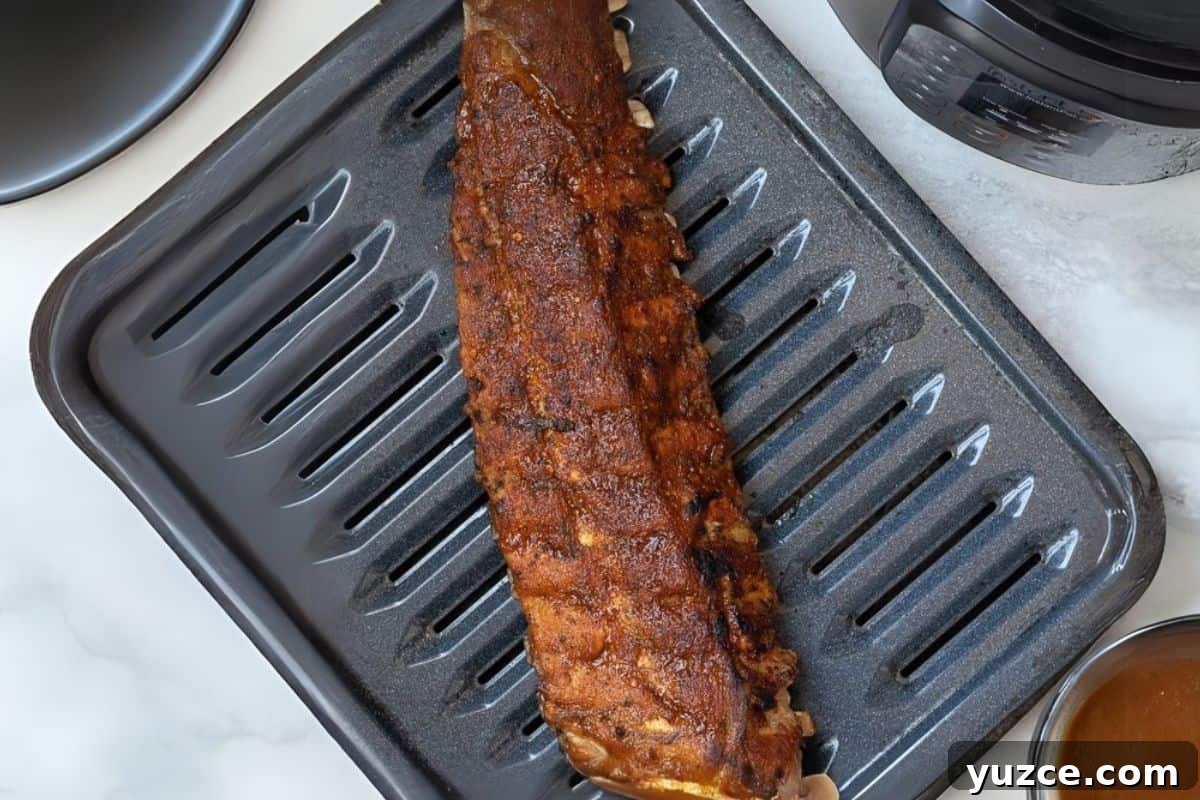 Instant Pot Rib Recipe Pressure cooked ribs on broiler pan after being pressure cooked.