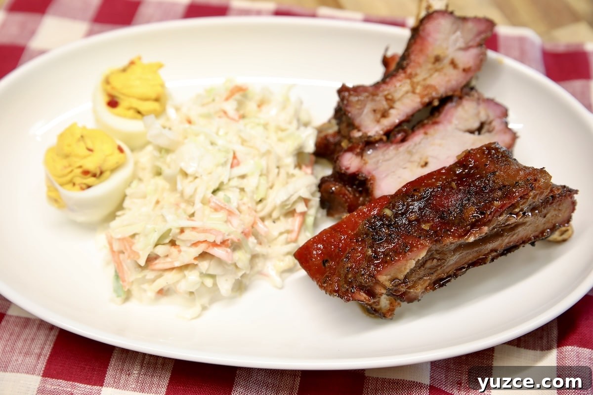 Spicy Maple-Glazed Ribs Recipe for Tangy, Caramelized Flavor 2 Platter of ribs, slaw and deviled eggs.