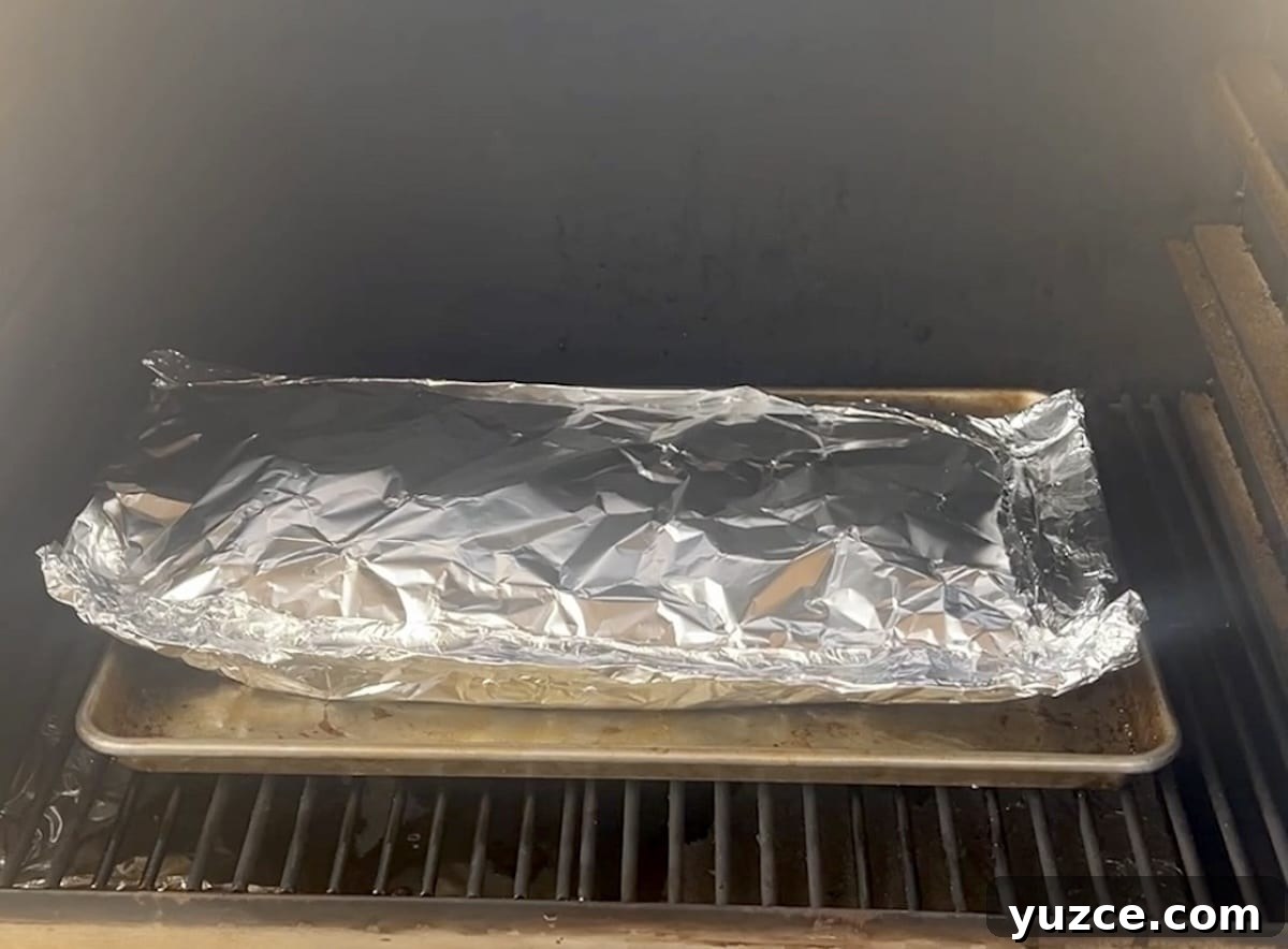 Spicy ribs on pellet grill. Foil wrapped ribs on a pellet grill.