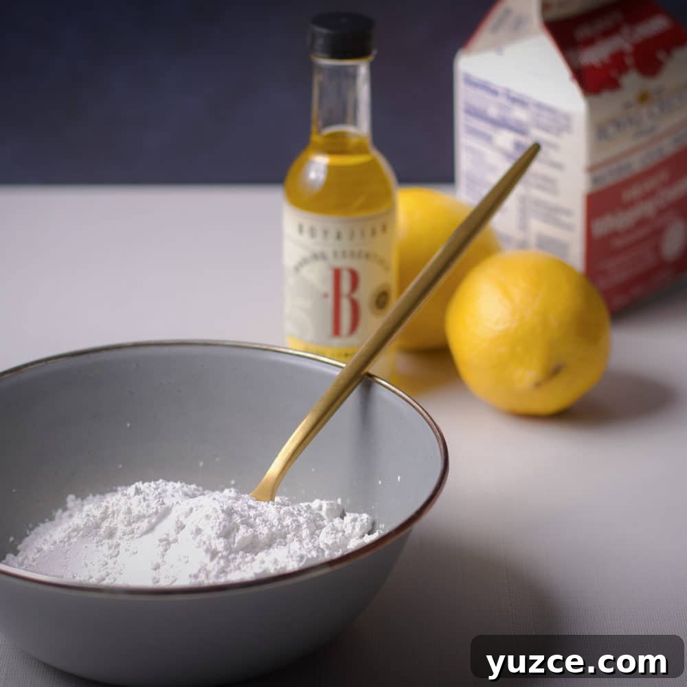 Lemon Glaze Recipe: Quick Zesty Icing for Cakes & Cookies 3 A photo showing the ingredients required to make lemon icing: powdered sugar, lemon juice, lemon oil, and heavy cream.