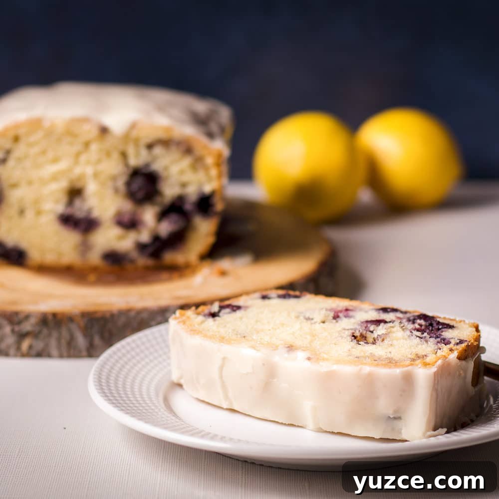 Lemon Glaze Recipe: Quick Zesty Icing for Cakes & Cookies 4 A slice of blueberry loaf cake with lemon icing on a white plate.