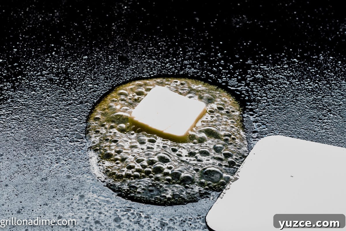 How to Make Over-Hard Eggs on a Blackstone Griddle 4 Melting butter on the griddle