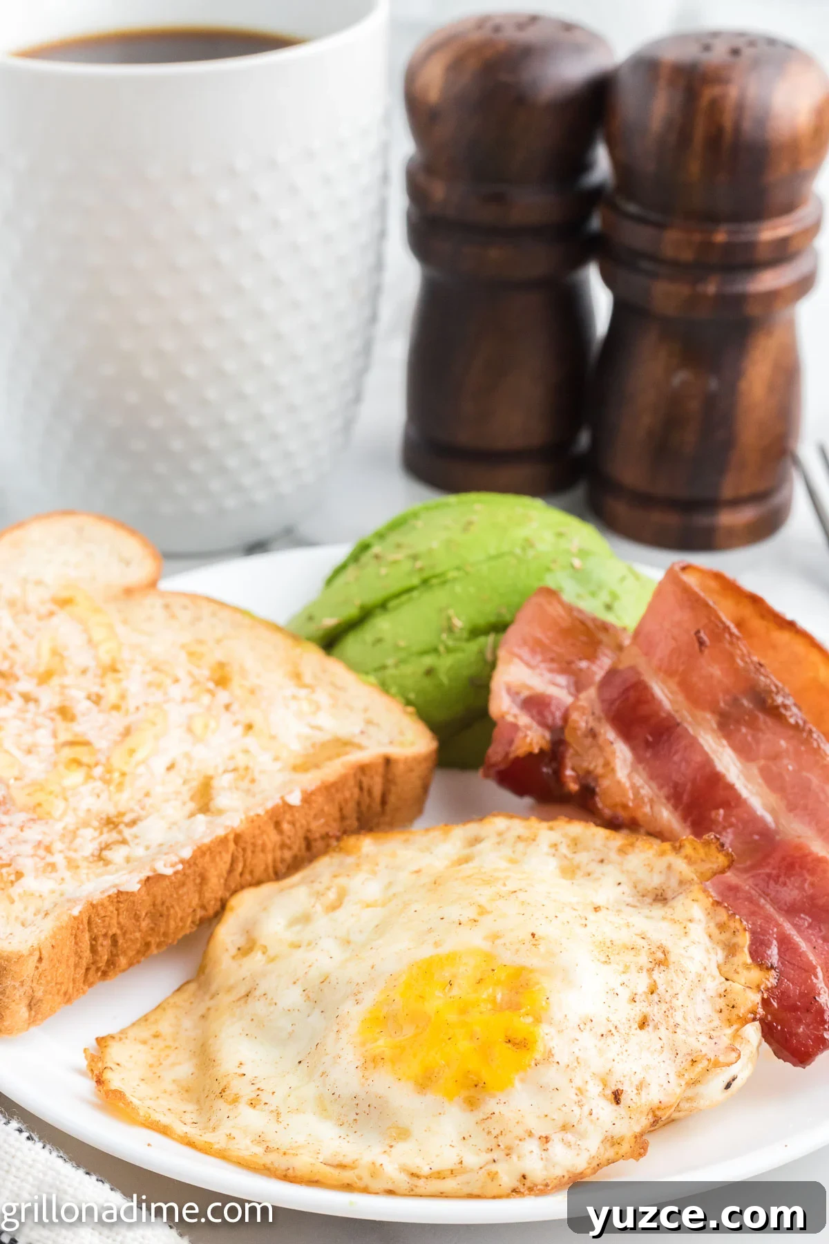 How to Make Over-Hard Eggs on a Blackstone Griddle 9 Over Hard Eggs on a plate with bacon and toast
