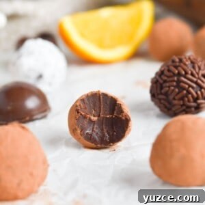 Decadent Chocolate Orange Truffle Recipe for Giftable Sweets 9 truffle with bite out of it with truffles around her.