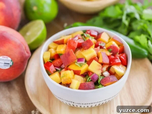 Zesty Black Bean and Corn Salsa Recipe for Fresh Homemade Dip 4 Easy peach salsa recipe in white bowl with ingredients scattered around.